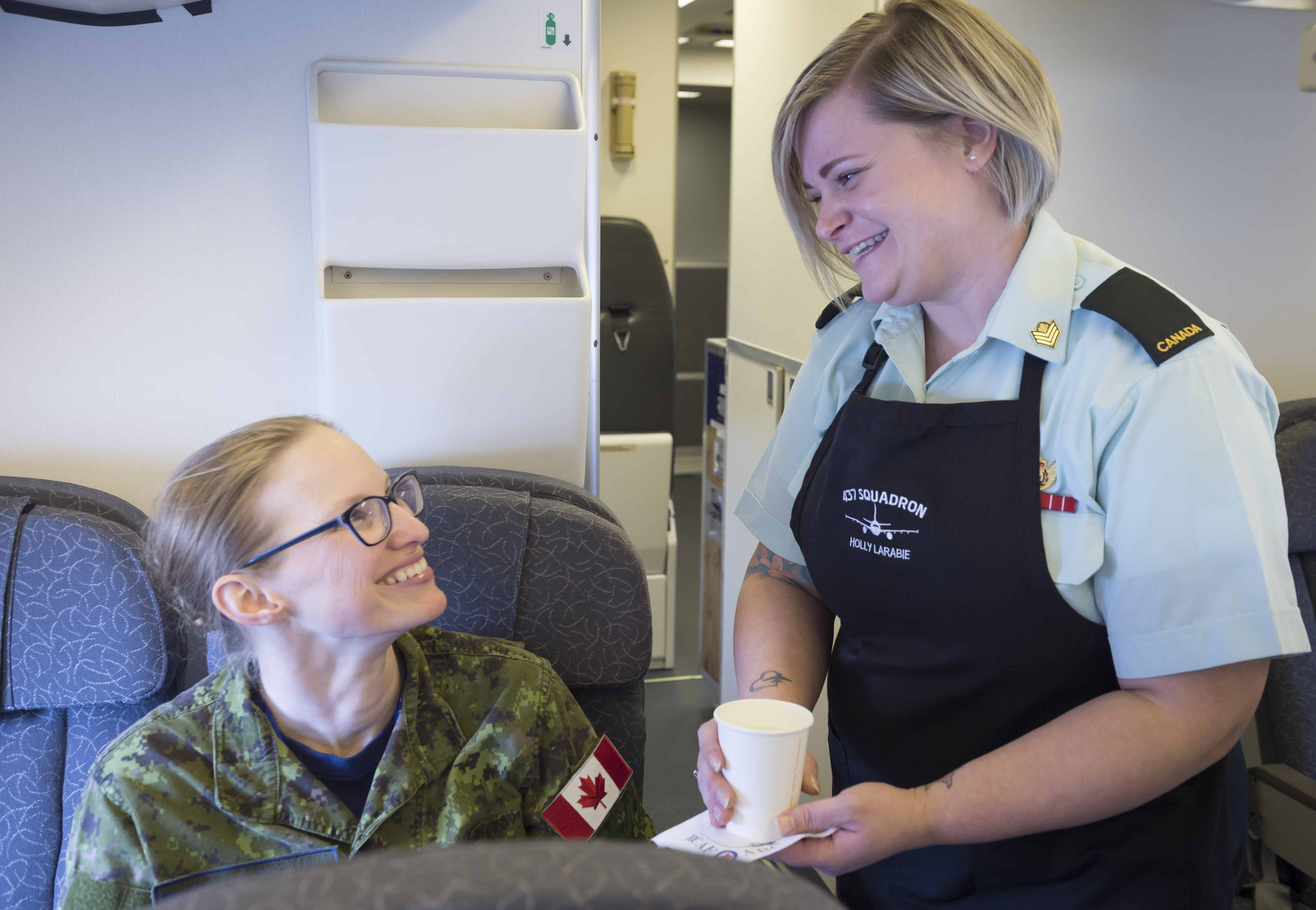 Sergeant Holly Larabie (right) says there is a lot more to her role on the aircraft than just passenger comforts. 
PHOTO: 8 Wing Imagery Section
