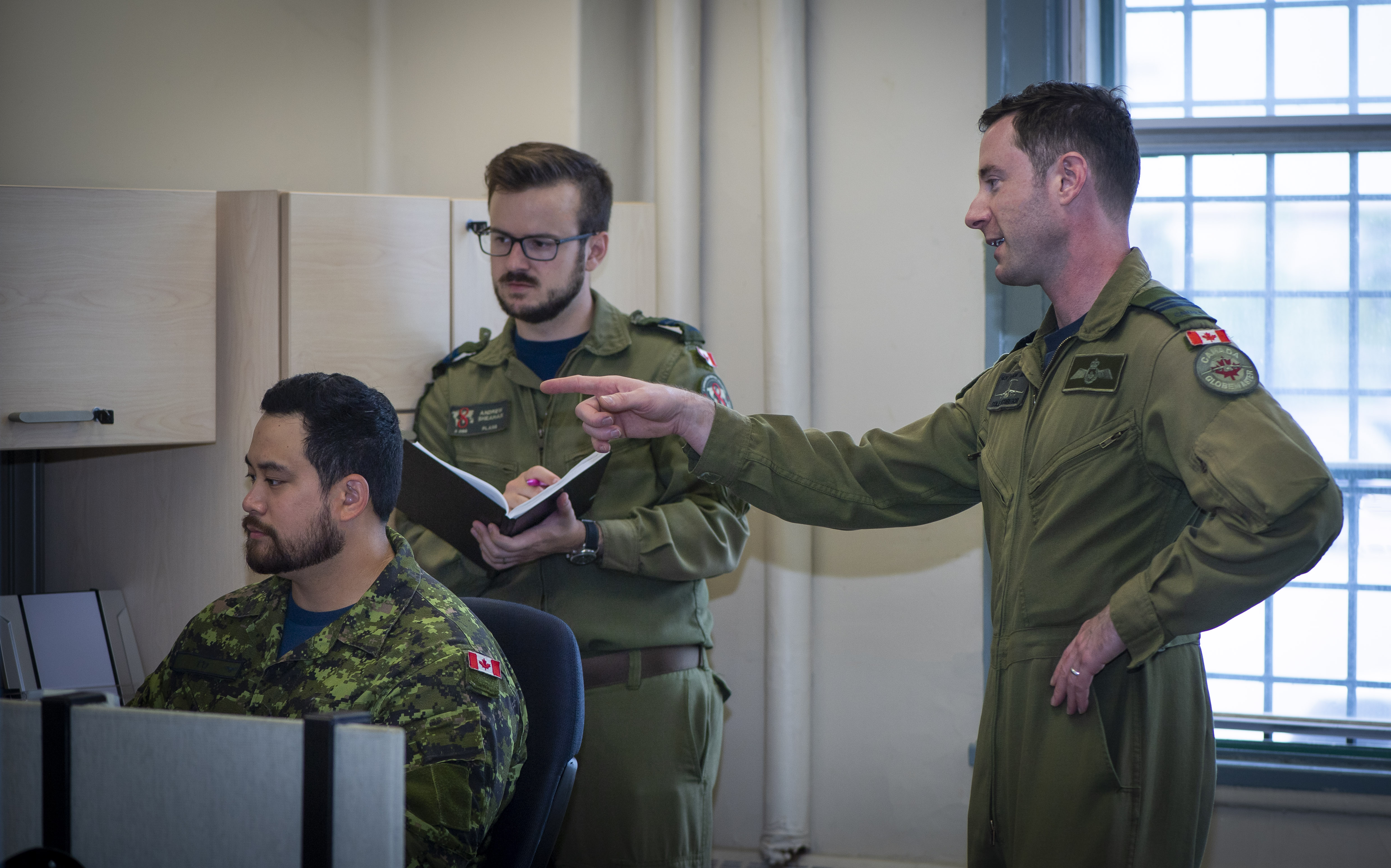 (Left to right) 2Lt Henry T’o, Capt Andrew Sheahan and Maj Cole McGregor, are the core members of the PITT Crew, working to analyze problems and find practical solutions. Photo: Pvt Natasha Puint, 8 Wing Imaging Section.